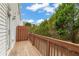 Private wooden deck offering outdoor relaxation and views of lush greenery at 240 Village Square Dr, Woodstock, GA 30188