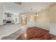Open dining room with hardwood floors adjacent to a modern kitchen and bright breakfast nook at 240 Village Square Dr, Woodstock, GA 30188