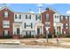 Attractive townhome exteriors featuring brick and siding, complemented by well-maintained landscaping at 240 Village Square Dr, Woodstock, GA 30188