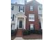 Charming townhome with a brick facade, covered entrance, and well-maintained landscaping at 240 Village Square Dr, Woodstock, GA 30188