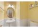 Charming powder room featuring a pedestal sink, wainscoting, and stylish lighting fixtures at 240 Village Square Dr, Woodstock, GA 30188