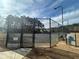 Outdoor tennis court with high metal fence at 240 Village Square Dr, Woodstock, GA 30188