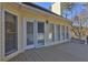 A large back porch features a white door with windows to the home's interior at 596 Whitby Dr, Douglasville, GA 30134