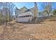 Back view of house with a deck and backyard featuring stairs to a lower level at 596 Whitby Dr, Douglasville, GA 30134