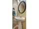Pedestal sink with an oval mirror and a towel in this simply elegant bathroom at 596 Whitby Dr, Douglasville, GA 30134