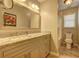 Bright bathroom features a granite countertop, a vanity with drawers, and modern lighting fixtures at 596 Whitby Dr, Douglasville, GA 30134