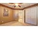 Neutral carpeted bedroom features traditional ceiling trim, two pictures and a double-door closet at 596 Whitby Dr, Douglasville, GA 30134