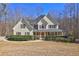 Charming yellow home features red shutters, a welcoming front porch, and a well-maintained lawn at 596 Whitby Dr, Douglasville, GA 30134