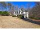 Spacious yellow two-story home with a covered porch, surrounded by trees and a large front yard at 596 Whitby Dr, Douglasville, GA 30134