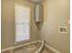 The laundry room has a large window, a cabinet and tile floor at 596 Whitby Dr, Douglasville, GA 30134