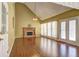 Inviting living room featuring a cozy fireplace, high ceilings, and beautiful French doors at 596 Whitby Dr, Douglasville, GA 30134