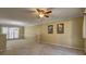 Spacious living room featuring neutral carpet, ceiling fan, crown molding, and plentiful natural light at 596 Whitby Dr, Douglasville, GA 30134