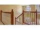 A staircase with wooden banister and neutral carpet leads to the main floor of this home at 596 Whitby Dr, Douglasville, GA 30134