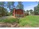 View of backyard with brick exterior, patio, and lush greenery at 1172 Martin Nash Sw Rd, Lilburn, GA 30047