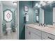 Hall bathroom with a single vanity, shower-tub combo, and a unique stained glass window at 1870 Shoreline Trce, Grayson, GA 30017