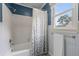 Clean bathroom showcasing a white tub and shower with a patterned shower curtain at 1870 Shoreline Trce, Grayson, GA 30017