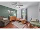 Bright bedroom featuring hardwood floors, natural light, and a comfortable seating area at 1870 Shoreline Trce, Grayson, GA 30017