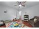 Bedroom featuring hardwood floors, neutral walls, and a ceiling fan at 1870 Shoreline Trce, Grayson, GA 30017