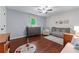 Bedroom features hardwood floors, bright natural light, with a comfortable chair and modern crib at 1870 Shoreline Trce, Grayson, GA 30017