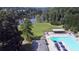 Top-down view of a community pool with lounge chairs and umbrellas for a relaxing summer at 1870 Shoreline Trce, Grayson, GA 30017