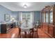 Elegant dining room with a large wooden table, classic china cabinet, and large window at 1870 Shoreline Trce, Grayson, GA 30017