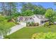 Spacious home with a two-car garage, manicured lawn, and mature trees at 1870 Shoreline Trce, Grayson, GA 30017