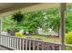 Covered front porch view with serene landscaping, providing a relaxing outdoor space at 1870 Shoreline Trce, Grayson, GA 30017