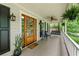 Charming front porch featuring a wooden door, hanging ferns, and cozy seating at 1870 Shoreline Trce, Grayson, GA 30017