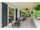 Inviting front porch with rocking chairs, ceiling fans, and decorative ferns at 1870 Shoreline Trce, Grayson, GA 30017