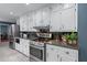Modern kitchen featuring stainless steel appliances, granite countertops, and white cabinets at 1870 Shoreline Trce, Grayson, GA 30017