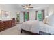 Bright main bedroom with porch access boasts hardwood floors, a ceiling fan, and neutral walls at 1870 Shoreline Trce, Grayson, GA 30017