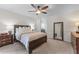 Relaxing main bedroom features a ceiling fan, neutral walls, and carpeted floors at 1870 Shoreline Trce, Grayson, GA 30017