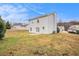 Backyard of home featuring a large grassy area, patio and mature trees at 4872 Antelope Cv, Atlanta, GA 30349