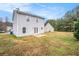 Backyard of home showcasing a large grassy area, patio and mature trees at 4872 Antelope Cv, Atlanta, GA 30349