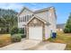 Charming home exterior with stone accents, a gray siding, and a one car garage at 4872 Antelope Cv, Atlanta, GA 30349