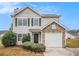 Charming two-story home with gray siding, black shutters, and stone accents around the garage at 4872 Antelope Cv, Atlanta, GA 30349