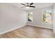 Cozy bedroom with ceiling fan, light walls, and two windows letting in natural light at 690 Avalon Forest Dr, Lawrenceville, GA 30044