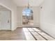 Elegant dining room with large window, chandelier, and light wood flooring at 690 Avalon Forest Dr, Lawrenceville, GA 30044