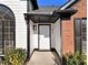 Close up of a front door featuring a decorative light and visible house number at 690 Avalon Forest Dr, Lawrenceville, GA 30044