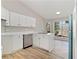 Bright kitchen features white cabinetry, stainless steel dishwasher, and a large window providing natural light at 690 Avalon Forest Dr, Lawrenceville, GA 30044