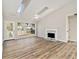 Bright living room featuring new flooring, skylights, and a cozy fireplace at 690 Avalon Forest Dr, Lawrenceville, GA 30044