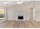 Inviting living room with a fireplace, hardwood floors, and a large window at 690 Avalon Forest Dr, Lawrenceville, GA 30044
