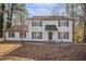 Traditional home with a classic white exterior, dark shutters, and a well-manicured lawn at 7935 Sweetwater Dr, Douglasville, GA 30135