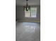 Dining room featuring tile floors, a window, and a chandelier at 1947 Kensington High Sw St, Lilburn, GA 30047