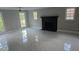 Spacious living room with a fireplace, large windows, and neutral paint color at 1947 Kensington High Sw St, Lilburn, GA 30047