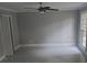 Bright living room with neutral paint, a ceiling fan, and a large window at 1947 Kensington High Sw St, Lilburn, GA 30047