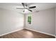 Bright bedroom featuring wood floors, ceiling fan and a window overlooking the outdoors at 3333 Devaughn Ne Dr, Marietta, GA 30066