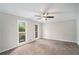 Large bedroom with plush carpet, ceiling fan, neutral paint and two windows at 3333 Devaughn Ne Dr, Marietta, GA 30066