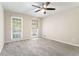 Cozy bedroom with two windows, and neutral gray carpet at 372 Rustic Ridge Cir, Lawrenceville, GA 30043