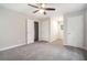 Spacious bedroom with fan and neutral gray carpet and walls at 372 Rustic Ridge Cir, Lawrenceville, GA 30043